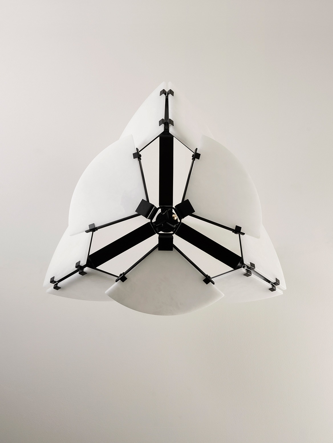Mcde-sus-102a-004 | rewire Modern pendant light fixture with white curved panels arranged like petals and a black geometric frame.