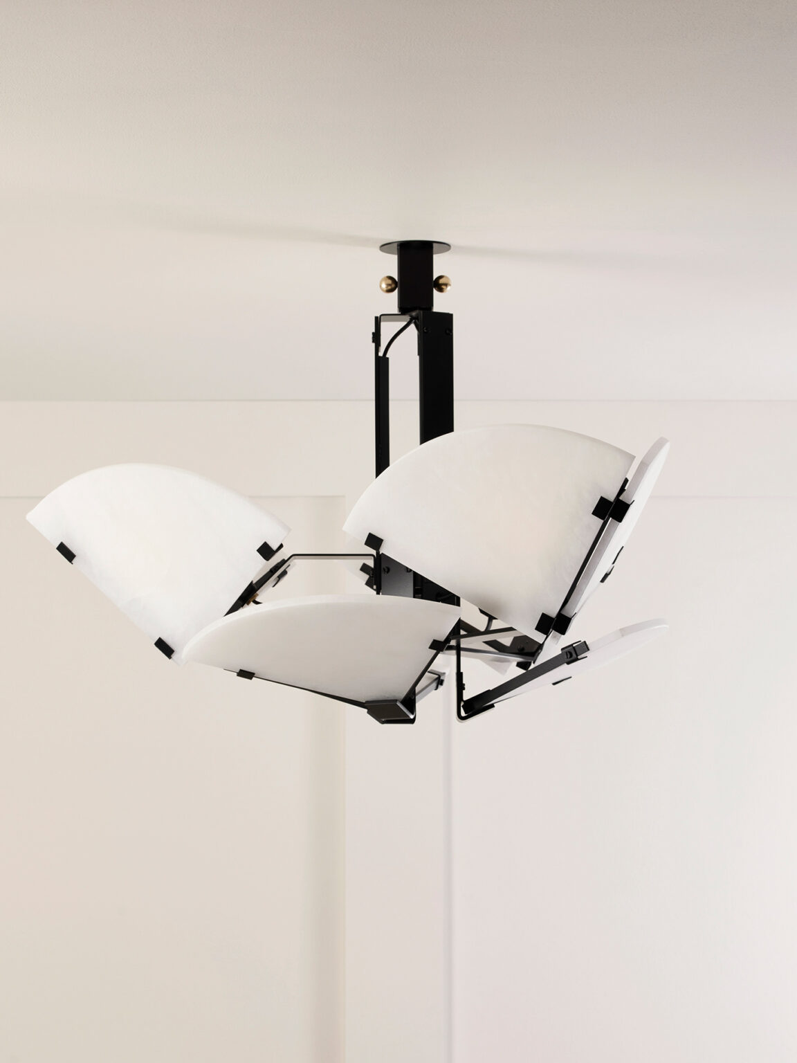 Mcde-sus-102a-007-1152x1536 | rewire Modern ceiling light fixture with white curved panels attached to a black central mount.