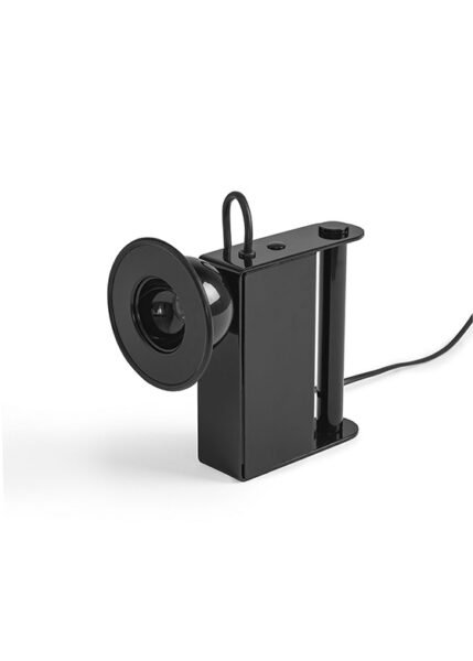 Small table light with a metal body a luminous eye that resembles a miner’s lamp.