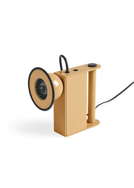 Small table light with a metal body a luminous eye that resembles a miner’s lamp.