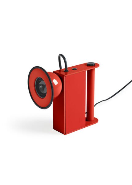 Small table light with a metal body a luminous eye that resembles a miner’s lamp.