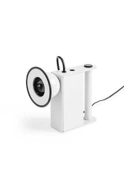 Small table light with a metal body a luminous eye that resembles a miner’s lamp.