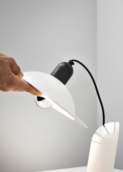 Wall/table light with a parabolic diffuser in aluminum and plastic is available in three color options.