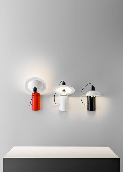 Wall/table light with a parabolic diffuser in aluminum and plastic is available in three color options.