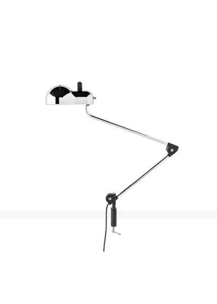 Topo lamp on a white background. The lamp has a metal shell with slits and a lampshade that corresponds to the classic E27 bulb casing. It has jointed metal arms for extending or retracting and is available in various finishes.