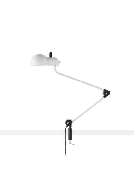 Topo lamp on a white background. The lamp has a metal shell with slits and a lampshade that corresponds to the classic E27 bulb casing. It has jointed metal arms for extending or retracting and is available in various finishes.