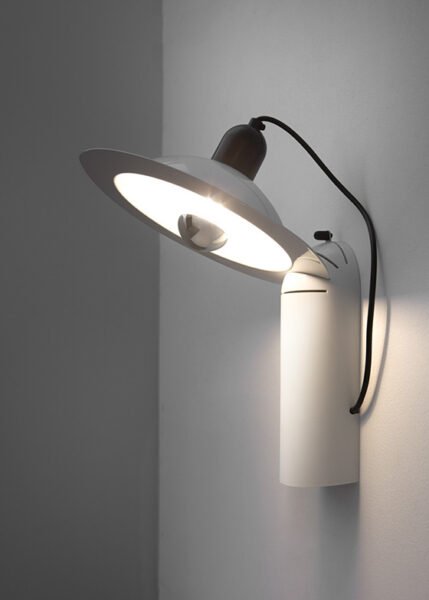 Wall/table light with a parabolic diffuser in aluminum and plastic is available in three color options.