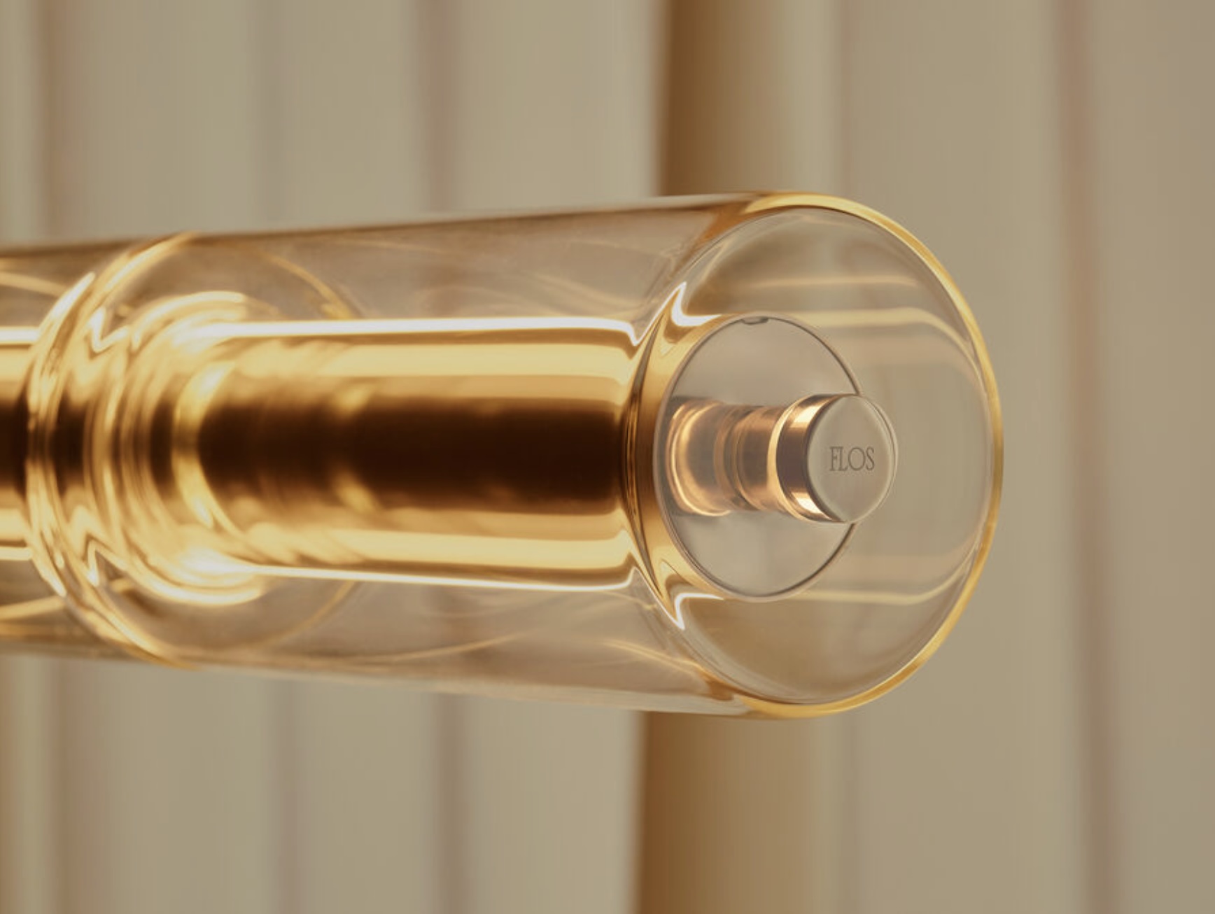 Screenshot | rewire Close-up of a gold-toned door handle with a circular end cap labeled EOS
