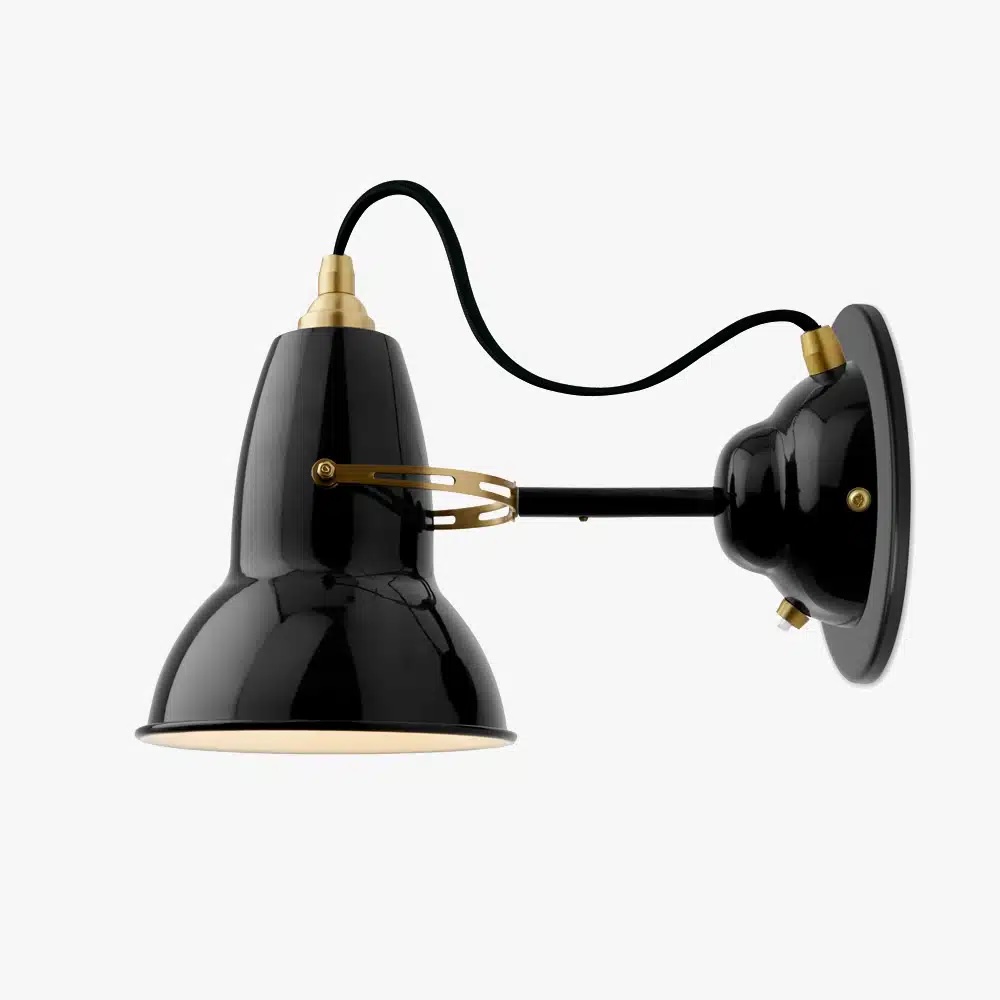 Original-1227-brass-wall-light-deep-slate-1jpg | rewire Black industrial wall lamp with gold accents, mounted on a circular wall plate and arm extending outward