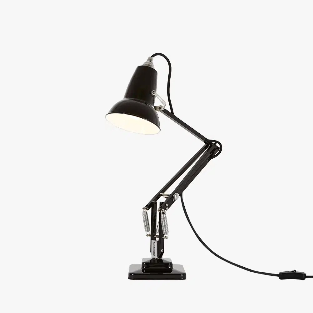 Original-1227-mini-desk-lamp-jet-black-3jpg | rewire Black adjustable desk lamp with clamp base and exposed power cord, lit from the shade top edge at a slight angle.