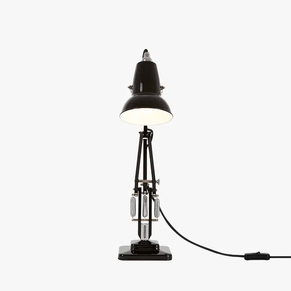 Original-1227-mini-desk-lamp-jet-black-4jpg | rewire Black industrial desk lamp with an adjustable triple-arm frame and a wide shade, plugged in with the cord trailing to the right.