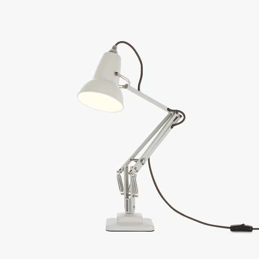 Original-1227-mini-desk-linen-white-3jpg | rewire White adjustable desk lamp with articulated arms and clamp base, plugged in and lit on.