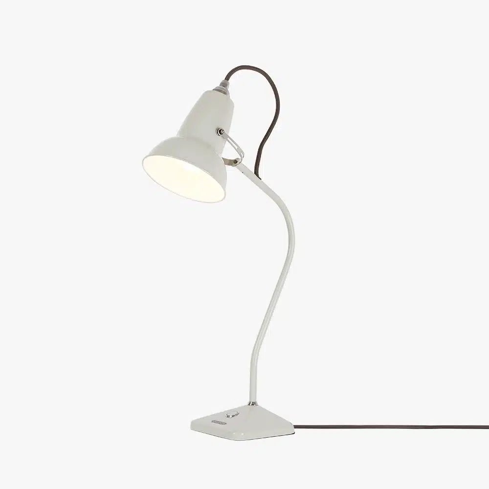 Original-1227-table-lamp-linen-white-2jpg | rewire White adjustable desk lamp with a curved neck and conical shade on a white base, plugged in on a plain surface.