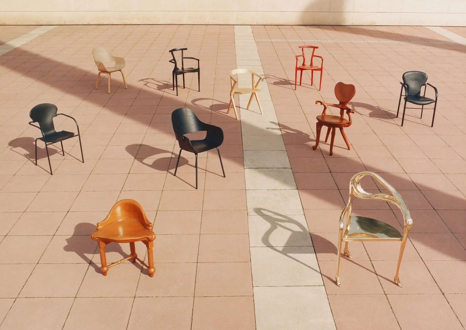 Assorted chairs scattered across a sunlit tiled plaza, long shadows cast by the sun