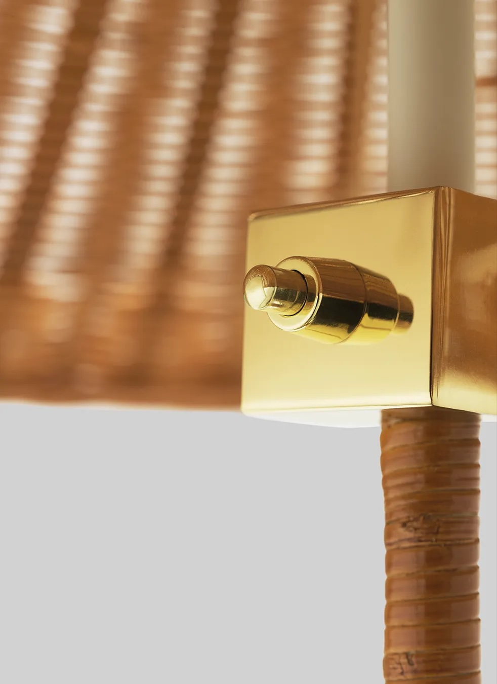 10003869_c4_9602+floor+lamp_brass_wicker+willow | rewire Close-up of a gold wall-mounted dimmer switch with a round knob on a brass plate.