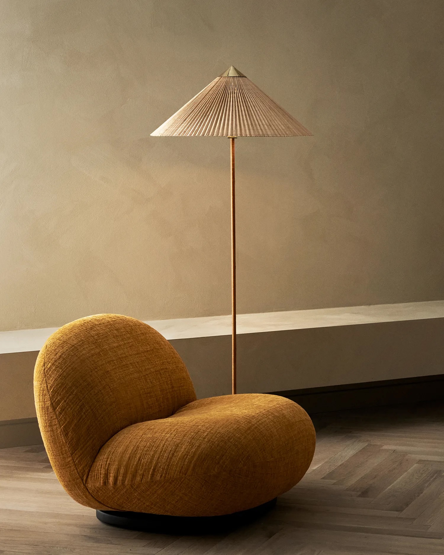10121232_l_9602+floor+lamp_bamboo+shadepng | rewire Orange rounded lounge chair with a tall pleated floor lamp in a minimalist living room.
