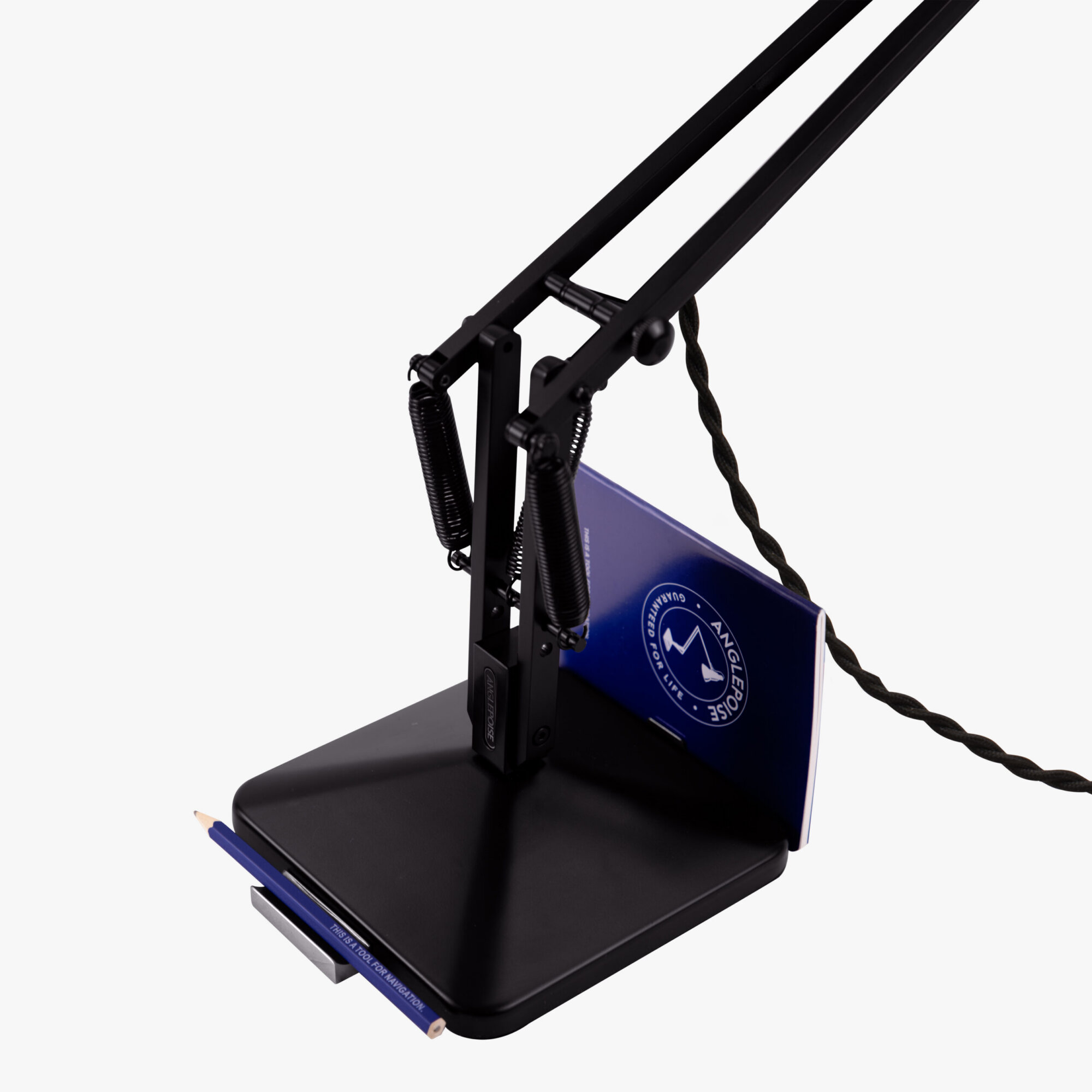 Original-315-desk-lamp-silver-black_2926ct_sq_wd1ob_6-scaled | rewire Close-up of a black metal frame with two diagonal rails, springs, and a blue panel attached, set against a light background.