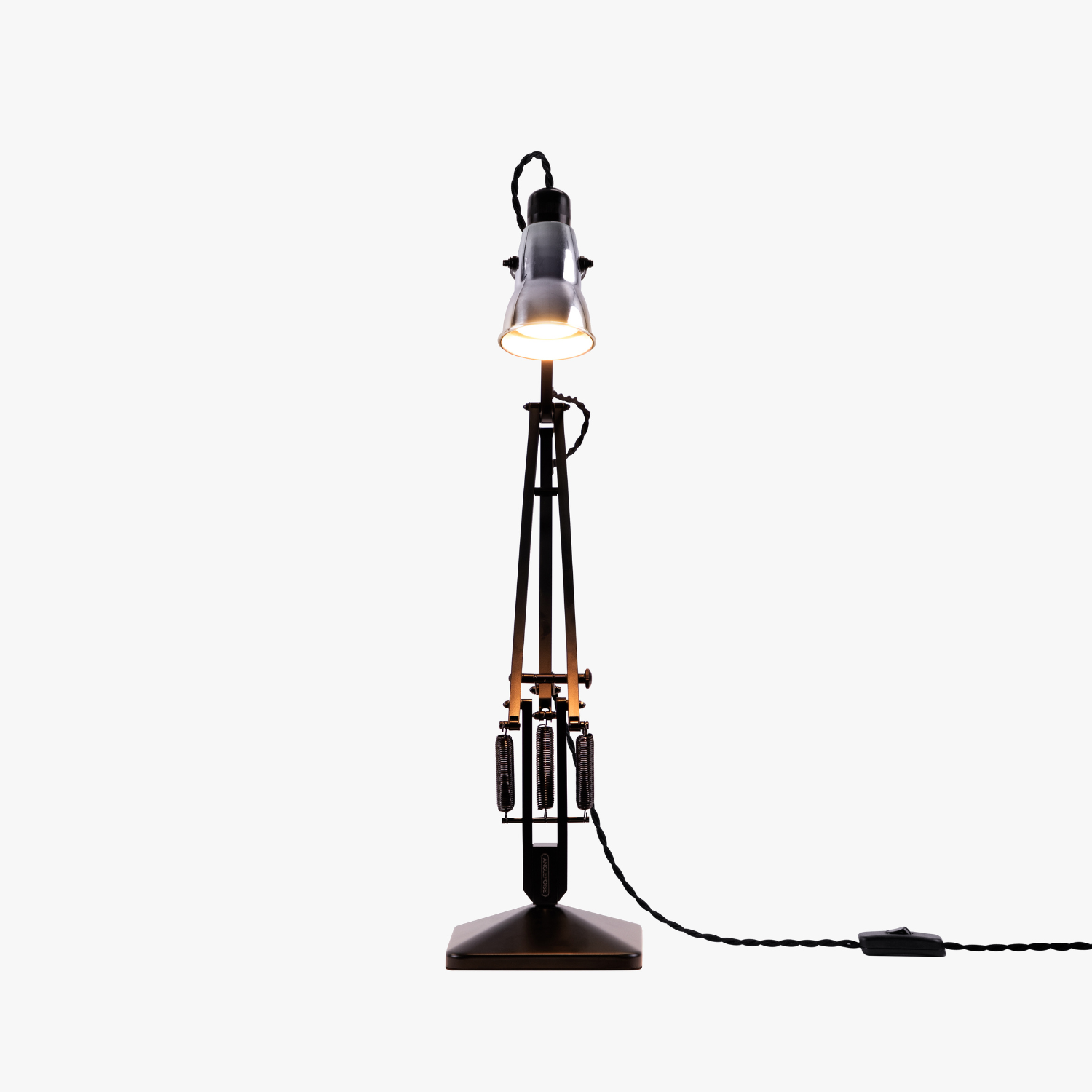 Original-315-desk-lamp-silver-black_2926ct_sq_wf1ob2_ | rewire Industrial desk lamp with a tall metal stand, illuminated bulb, and braided power cord trailing to the switch.