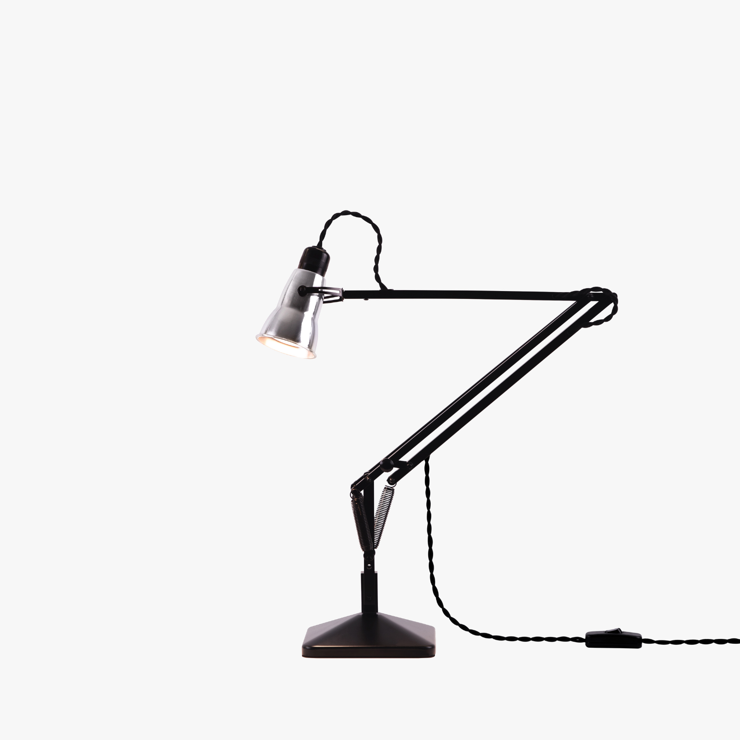 Original-315-desk-lamp-silver-black_2926ct_sq_ws3ob2_ | rewire Black adjustable desk lamp with metal shade and twisted cord on a sturdy base used for task lighting.